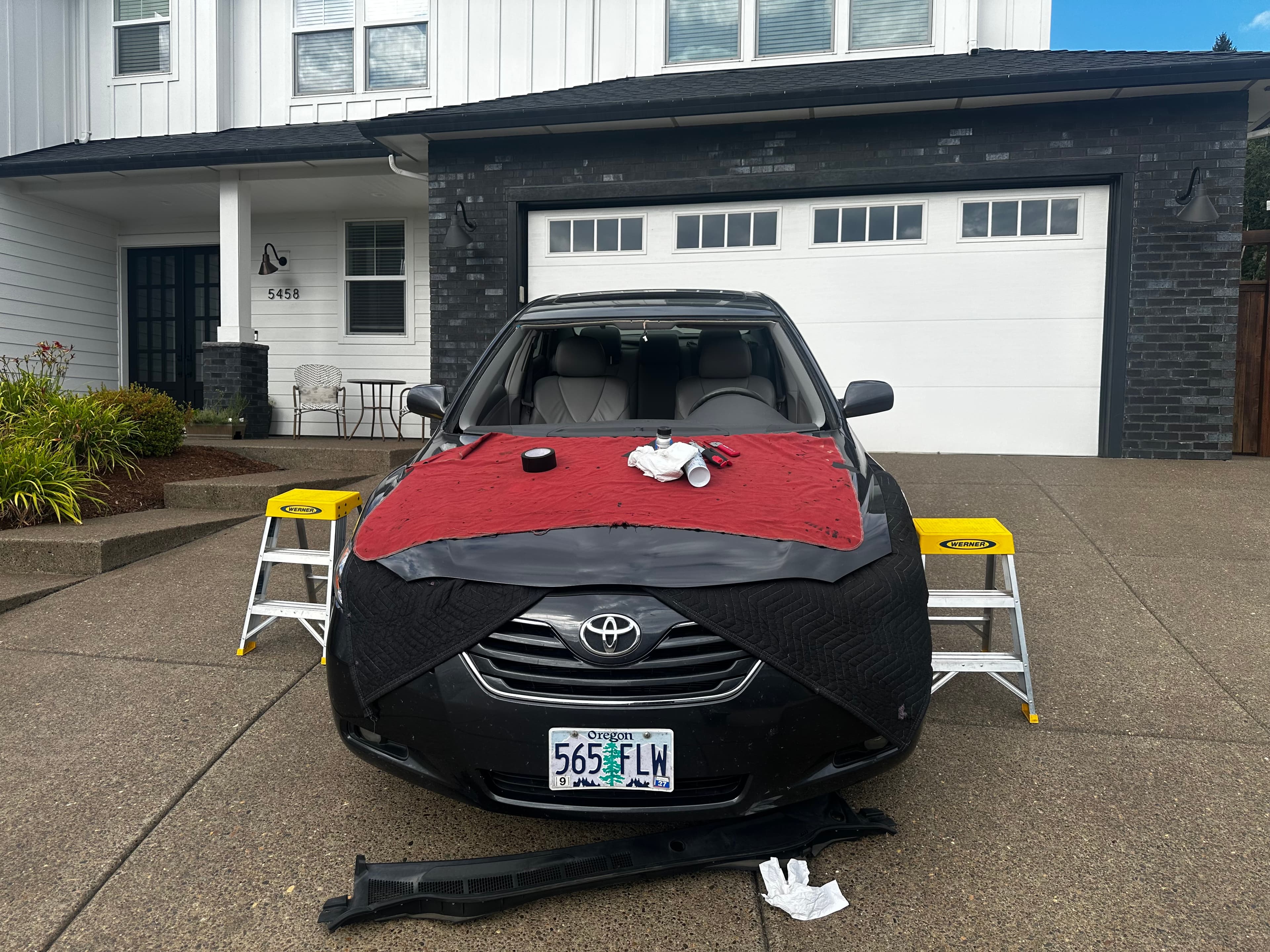 Technician setting a new windshield with a professional tool